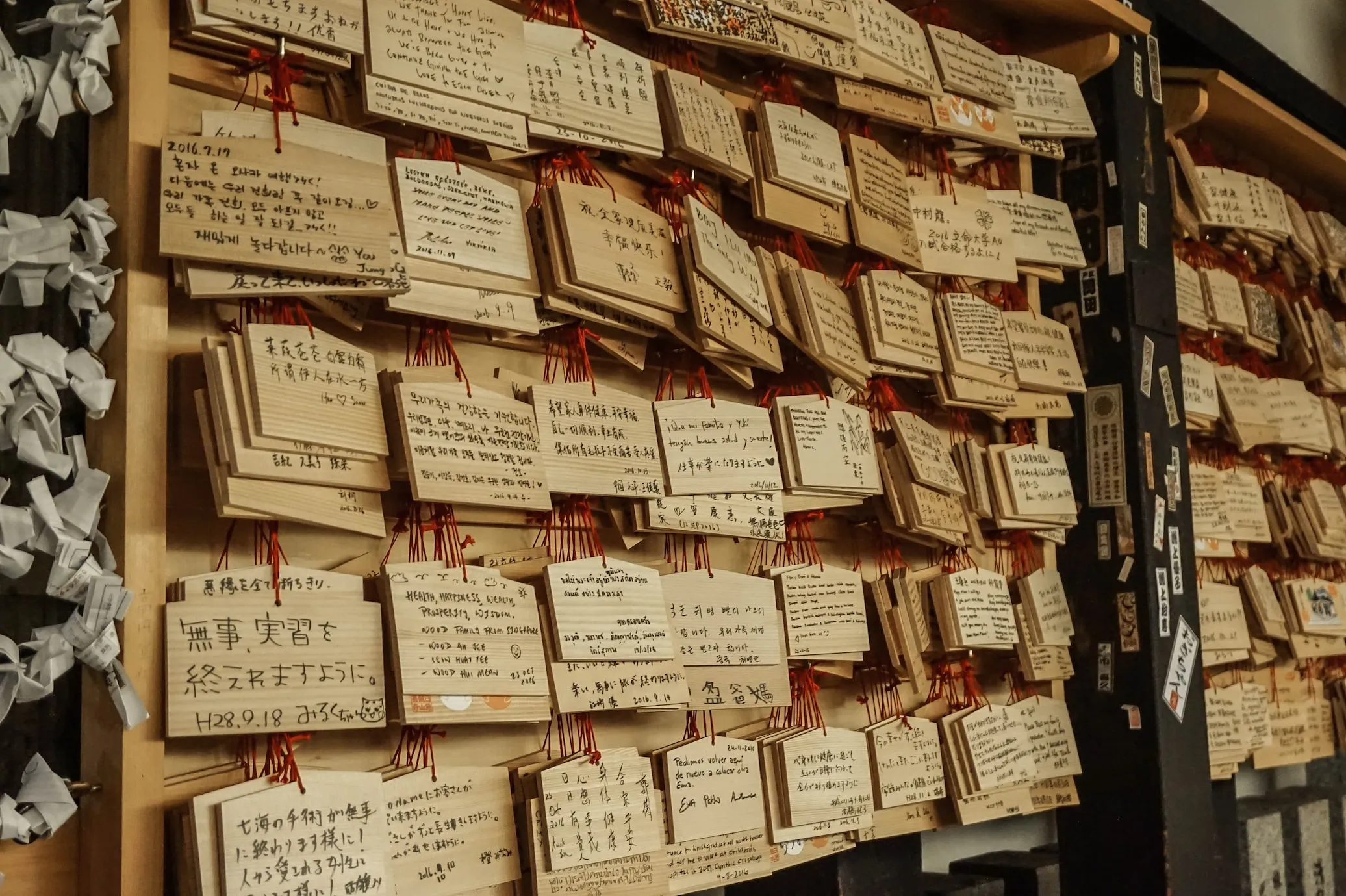 Bunch of tags hanging up on a cardboard wall