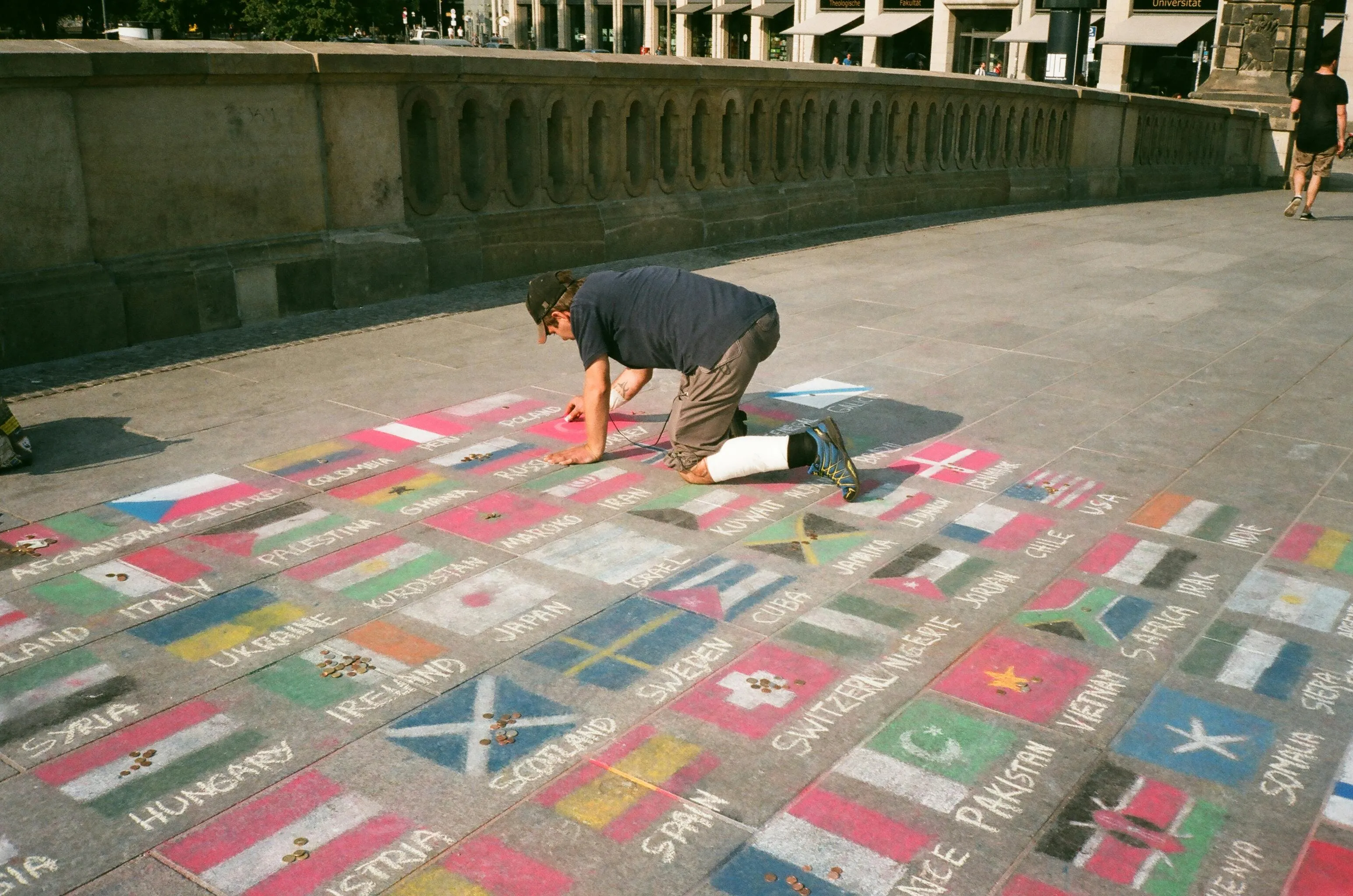 Person drawing flags on the ground